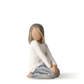 Front view of kneeling figure with short hair wearing blue jeans and cream shirt