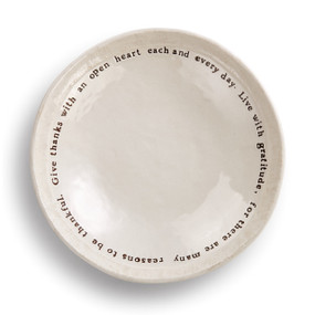 Round cream plate with black quote on the side