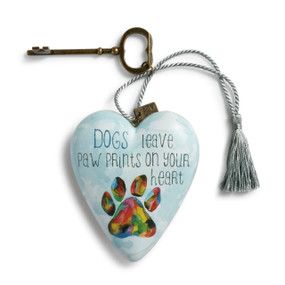 Light blue heart pendant with 'dogs leave paw prints on your heart' in black letters above multi-color dog print - gold key and blue tassle attatched