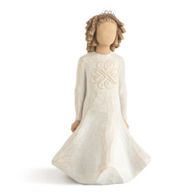 Front view of standing female figure in cream dress with full skirt and curly hair with gold wire crown, dress carved with Celtic knot