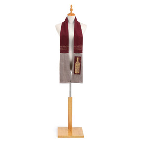 maroon and gray kitchen towel in the shape of a scarf wrapped around the neck of a mannequin with wine bottle decal which reads 'any friend of wine is a friend of mine' on one of the ends