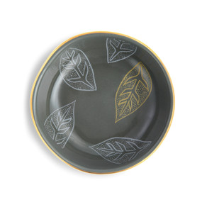 top view of gray bowl with gold rim and blue and yellow leaf pattern on inside