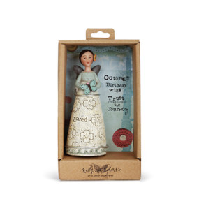 Angel figurine with brown hair and wings wears a dress with a light blue top and cream skirt. LIght blue decal around base of skirt. Angel has an orange flower in her hair and holds a blue butterfly. Angel is in brown gift packaging
