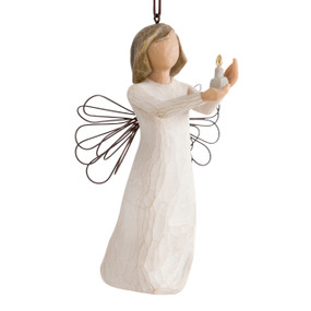 Figure with short brown hair wearing cream dress holding out a candle in her hands, ornament hook attached to head