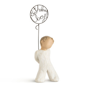 Front view of small standing boy figure holding wire balloon with "birthday boy" written in wire inside it