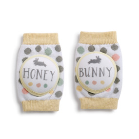 Set of two baby socks - white background with grey/pink polka dots and pale yellow tops and bottoms - left one says 'honey' right one says 'bunny' in light grey