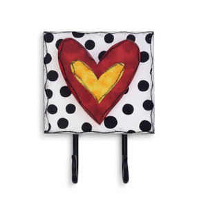 White square hook with black polka dots and red heart in the center