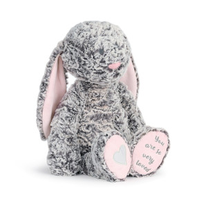 gray and light pink fluffy stuffed animal bunny reading You Are So Very Loved on bottom of foot