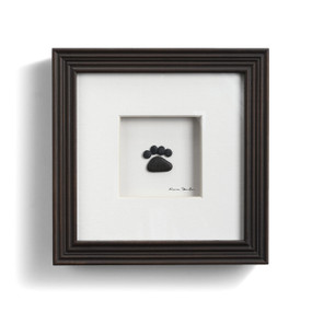 framed art made of pebbles depicting pawprint