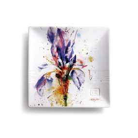 White platter with purple flower surrounded by multi-color splatter paint, artists signature in red located in the right corner