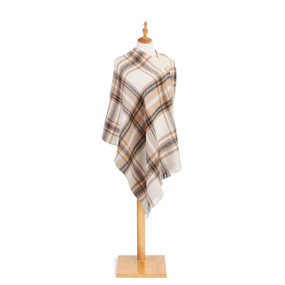 tan and white plaid poncho with large buttonso n one shoulder