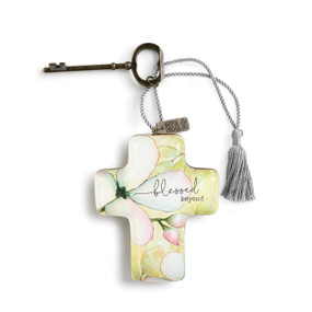 small cross with pink and green flowers painted on it and Blessed Beyond printed in black tied to a metal key