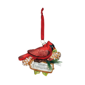 Side view of red cardinal bird ornament with white/black 'merry christmas' sign off it