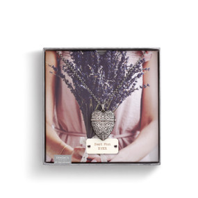 Box with image of woman holding purple flowers and silver heart pendant necklace with 'best mom ever' under it