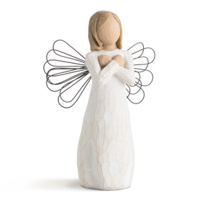 Front view of female figure in cream dress with wire wings, with hands crossed across chest