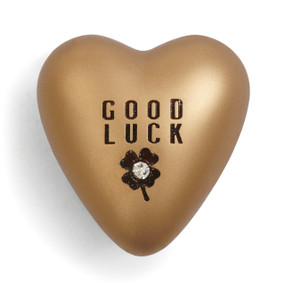 Gold heart figurine with Good Luck above four leaf clover carved in brown