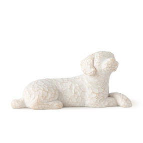 Figure of small white dog laying down with paws crossed in front, facing front