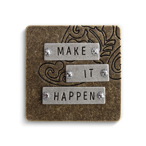 silver rectangles screwed into brown square magnet reading 'make it happen'