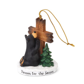 Black bear figurin ornament hugging a wooden cross - on round white plaque that says 'reason for the season' in black