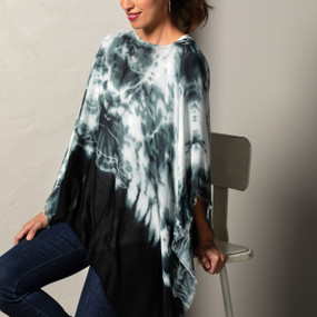 A white and blue tie dye printed poncho placed on an ivory and black mannequin.