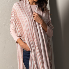 A striped light pink and cream Striped Duster. Placed on an ivory and black mannequin.