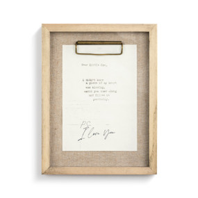 A white letter with black handwriting pinned into a wooden frame with burlap backing.