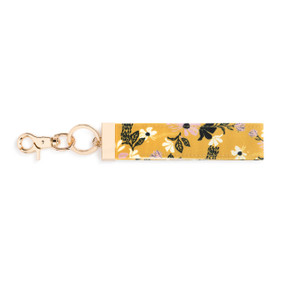 A yellow, black, and purple floral print wrist strap with gold metal accents.