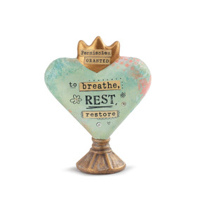 light blue heart on a stand with a crown and Permission Granted to Breathe Rest and Restore printed on front