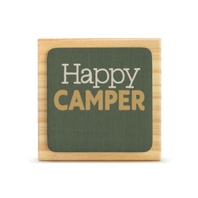 A square wood plaque with a dark green tile that says "Happy Camper".