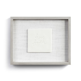 A gray frame enclosing a cream ceramic plate that reads "have faith".