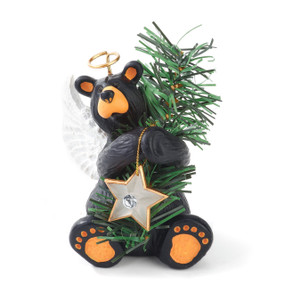 Black bear figurine sitting holding green christmas tree