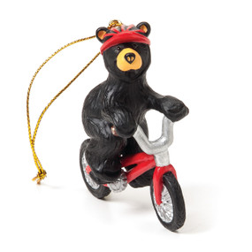 Black bear riding red bicycle ornament