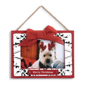 red and white picture frame with twine hanging thread and red bow reading Merry Christmas