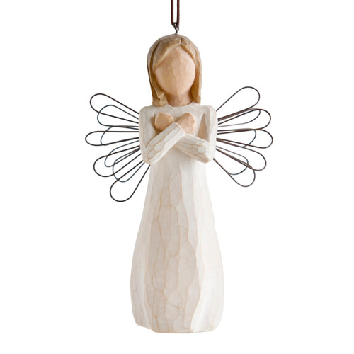 Figure in cream dress with wire wings and arms crossed in front of chest, ornament loop fixed to figure's head