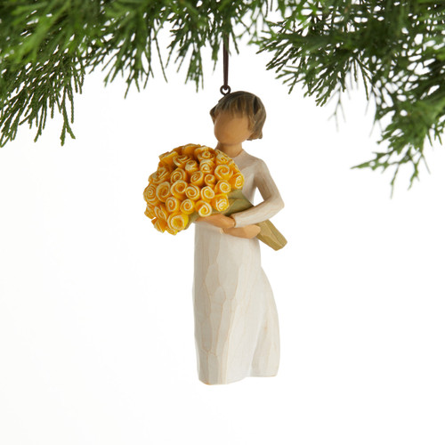 Front view, female figurine in cream dress, holding large bouquet of yellow roses. Hook and loop affixed to figure's head