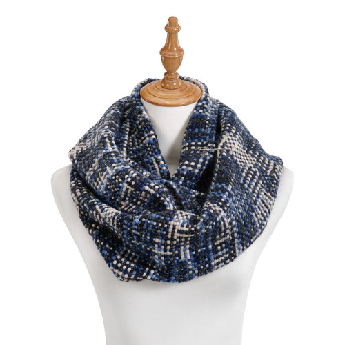 Close view of white mannequin stand with navy blue/white scarf around its neck