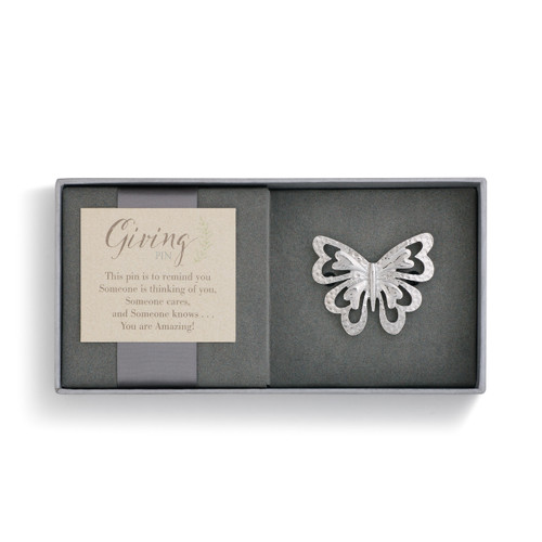 Light grey open jewerly box with Giving tag on left side, silver butterfly on right side