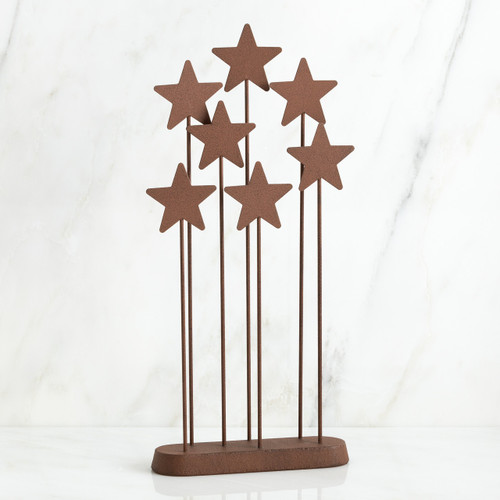 Set of standing brown star figurines on wooden plaque