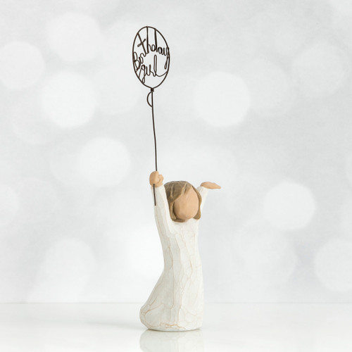 Left side view of little girl with brown hair and both arms in the air as she holds a wire balloon. Text on balloon is wire