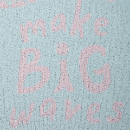 detail shot of pink and blue blanket that reads Make Big Waves