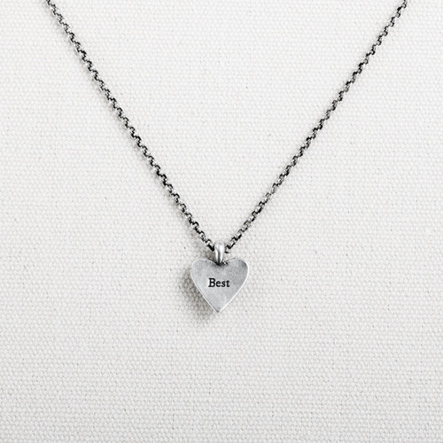 Silver chain holds silver heart pendant with engraved text: "Best"