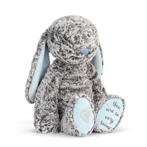 gray and light blue fluffy stuffed animal bunny reading You Are So Very Loved on bottom of foot