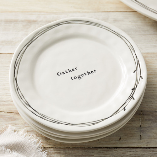 stack of white ceramic plates with Gather Together etched in middle with leaf and branch design encircling the edges