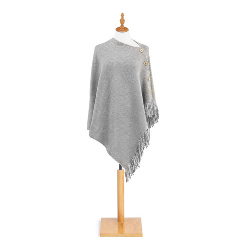 gray poncho with four large buttons down left arm and fringe on hem