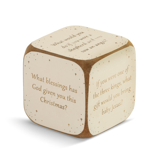 tan painted dice with questions about Christmas printed on it