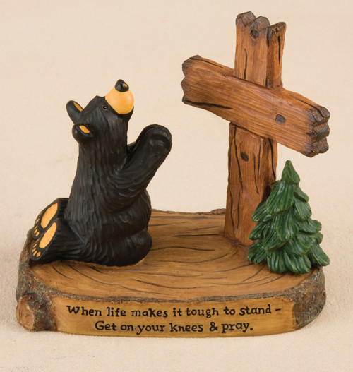 Black bear figurine kneeling on wooden plaque praying next to cross figurine - 'when life makes it tough to stand - get on your knees and pray' on it