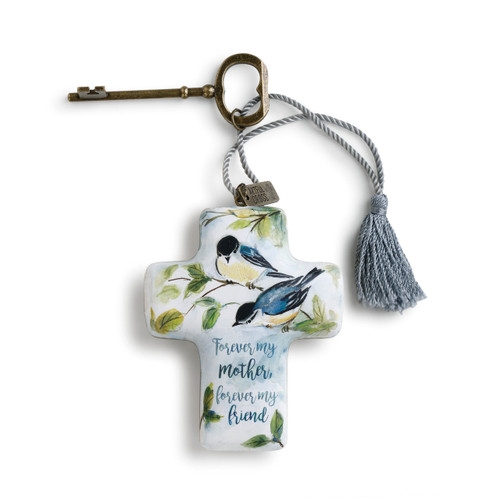 Light blue cross with birds perched on branches has blue text. Dusty blue tassel and bronze key are attached to top of heart