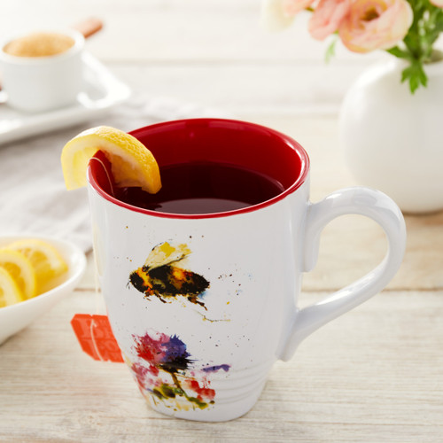 white ceramic mug with red painted inside with watercolor bee on front holding lemon tea
