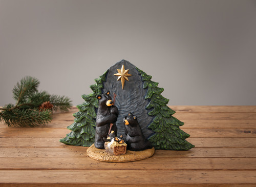 Set of two black bear figurines in manger scene with baby bear in basket