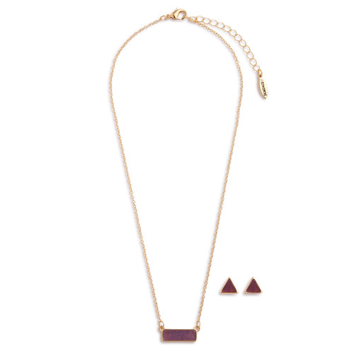 Gold necklace holds a pendant with light purple stones. To the right of the necklace are two gold, triangular earrings with light purple stones